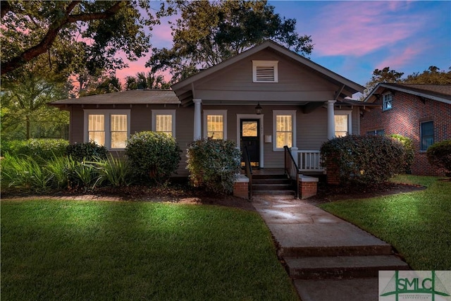 view of front of home featuring a front lawn and covered porch