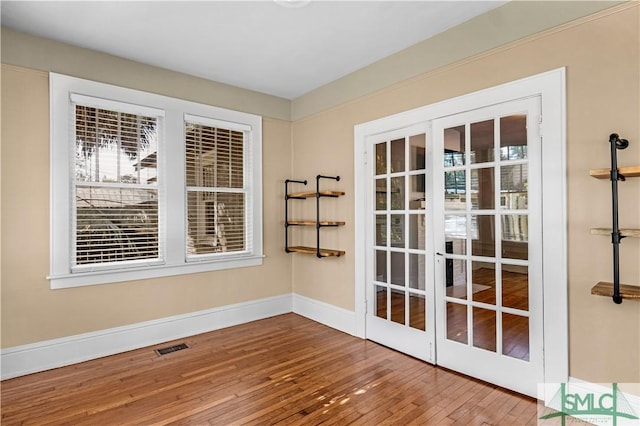 entryway with visible vents, french doors, baseboards, and wood-type flooring