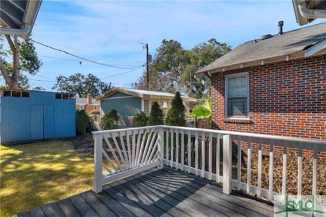 wooden terrace featuring an outdoor structure and a shed