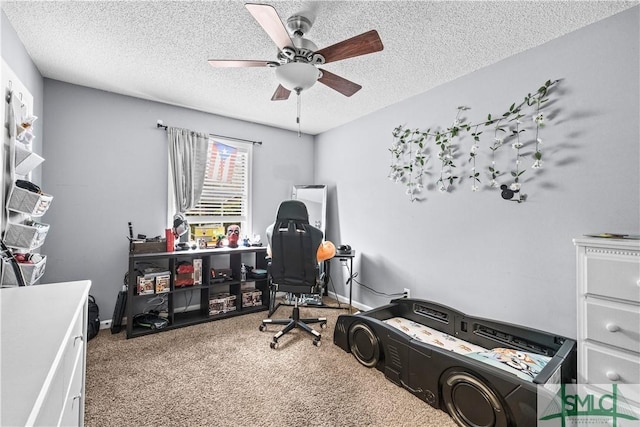 carpeted office space featuring ceiling fan and a textured ceiling