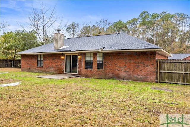 back of house featuring a yard and a patio area