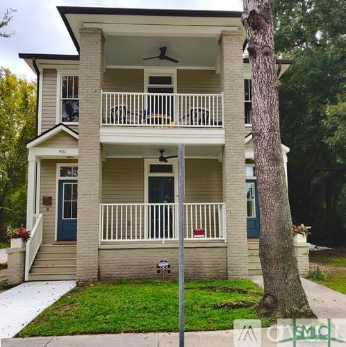 view of front of property featuring ceiling fan, covered porch, and a balcony