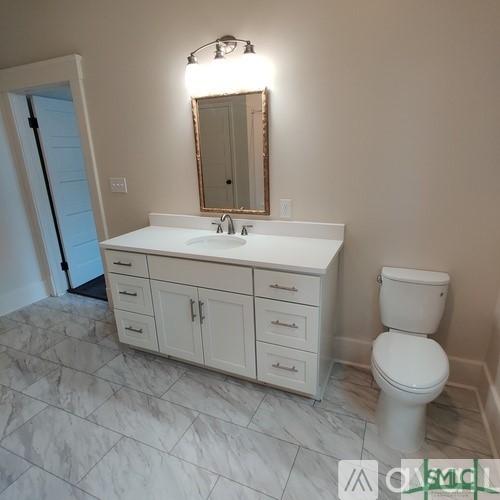 bathroom with vanity and toilet