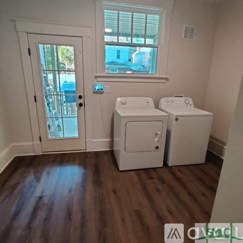 clothes washing area featuring dark wood-type flooring and independent washer and dryer