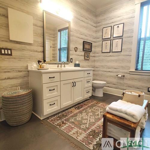 bathroom featuring vanity, toilet, and a wealth of natural light