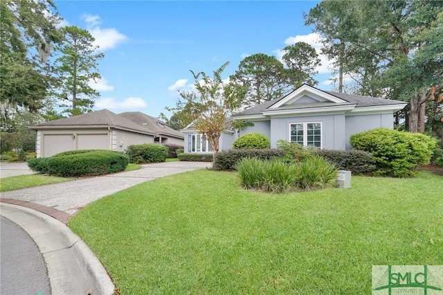 ranch-style home with a garage and a front yard