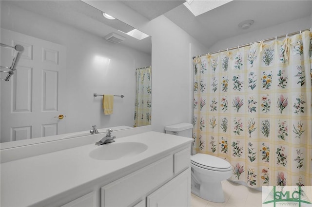 bathroom featuring vanity, toilet, and a skylight