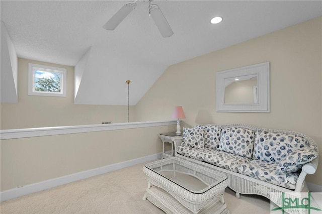 living room featuring lofted ceiling, light colored carpet, and ceiling fan