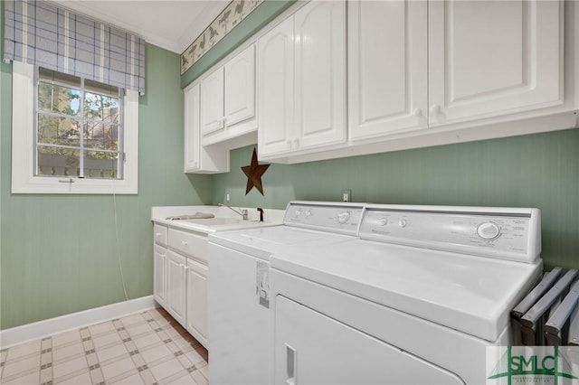 washroom featuring cabinets, independent washer and dryer, and sink