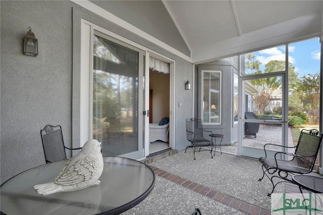 sunroom / solarium featuring lofted ceiling