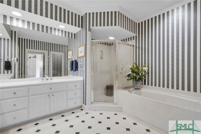 bathroom featuring vanity, ornamental molding, and separate shower and tub