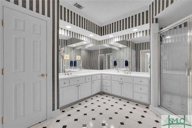 bathroom featuring crown molding, vanity, walk in shower, and a textured ceiling