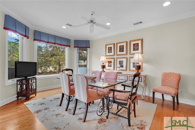 dining room featuring crown molding, light hardwood / wood-style floors, and ceiling fan