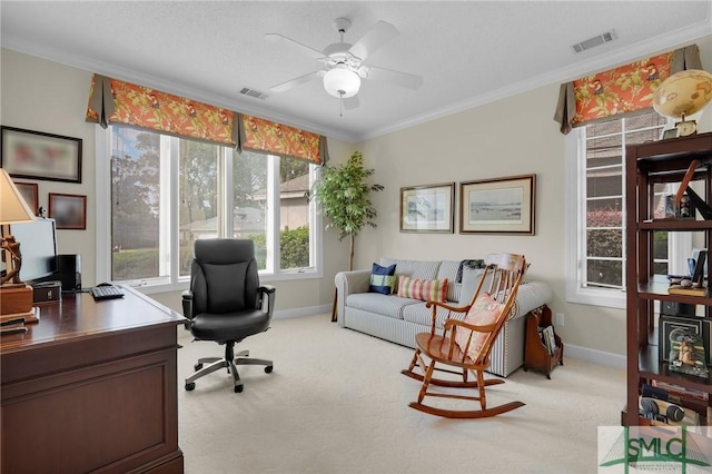 carpeted home office featuring ornamental molding and ceiling fan