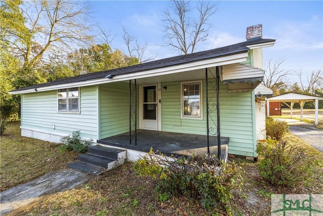 view of front of house featuring a carport and a porch