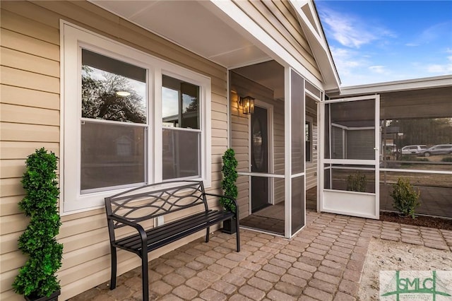 view of patio / terrace featuring a sunroom