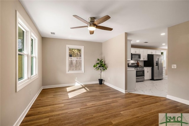 empty room featuring hardwood / wood-style flooring and ceiling fan