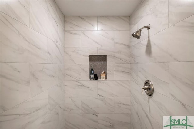 bathroom with tiled shower