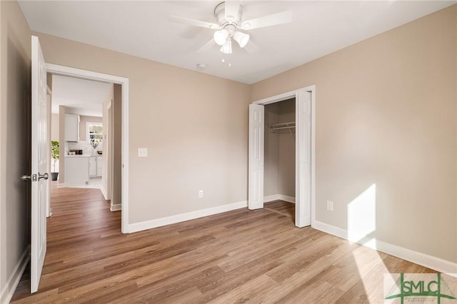 unfurnished bedroom with ceiling fan, light hardwood / wood-style floors, and a closet