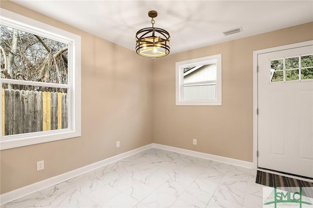 empty room with an inviting chandelier