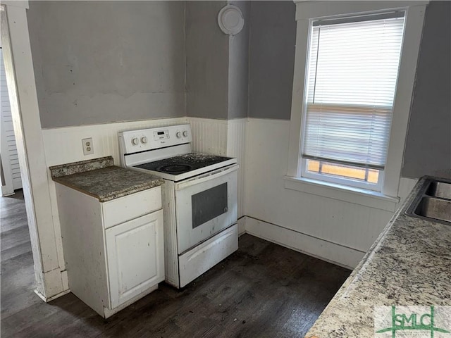 kitchen with dark hardwood / wood-style floors, white cabinets, and white range with electric cooktop