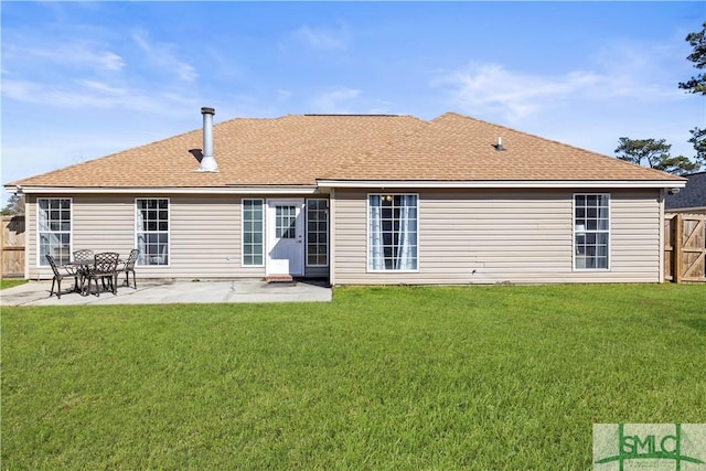 rear view of property featuring a patio area and a lawn