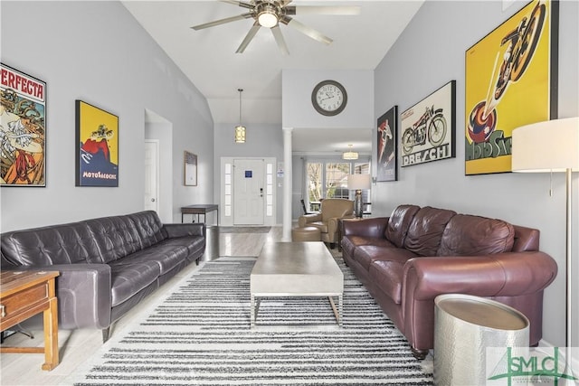 living room with ceiling fan, high vaulted ceiling, and ornate columns