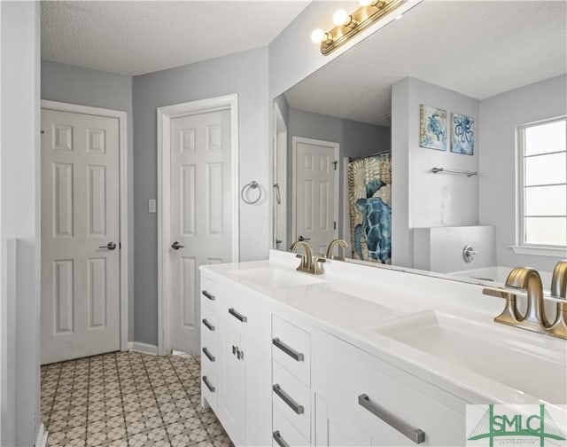 bathroom with vanity and a textured ceiling