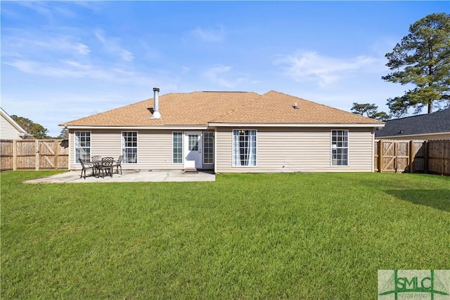 rear view of house with a yard and a patio area