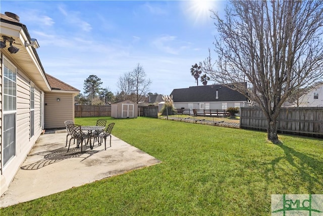 view of yard featuring a patio and a storage shed