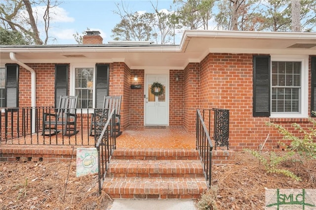 property entrance with covered porch