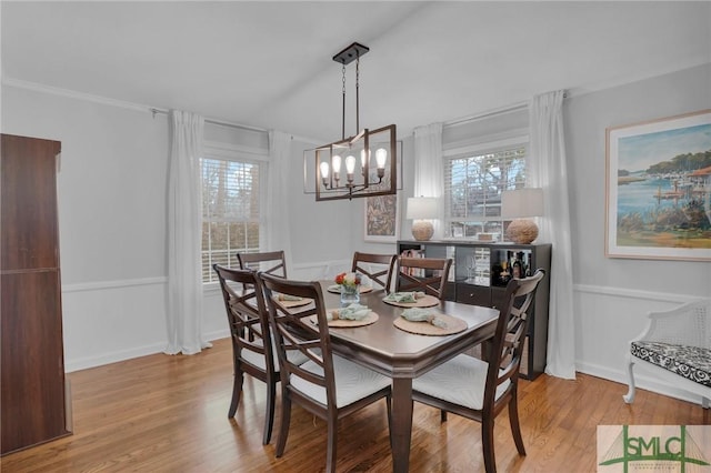 dining area featuring a healthy amount of sunlight, a chandelier, and light hardwood / wood-style flooring