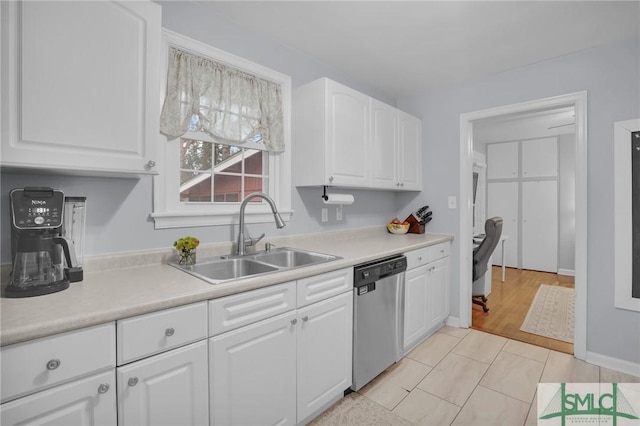 kitchen with dishwasher, sink, and white cabinets