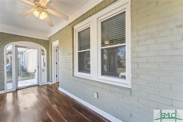 unfurnished sunroom with ceiling fan