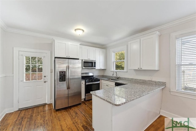 kitchen featuring plenty of natural light, light stone countertops, white cabinets, and appliances with stainless steel finishes