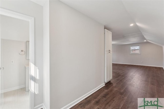 bonus room with lofted ceiling and dark hardwood / wood-style floors