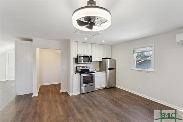 kitchen with dark wood-type flooring, stainless steel appliances, and white cabinets