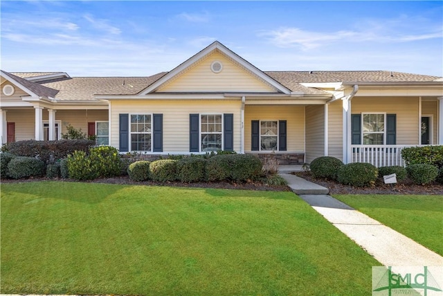 ranch-style house featuring a porch and a front yard