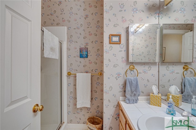 bathroom with vanity and a shower with shower door