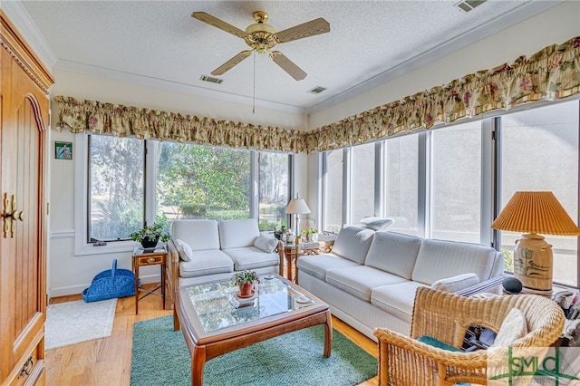 sunroom / solarium featuring ceiling fan