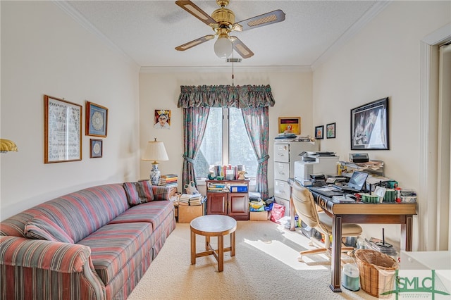 living room with ceiling fan, ornamental molding, carpet flooring, and a textured ceiling