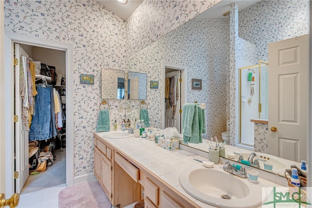 bathroom with walk in shower, vanity, toilet, and tile patterned flooring