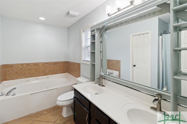 bathroom featuring toilet, a textured ceiling, vanity, a bathtub, and tile patterned flooring