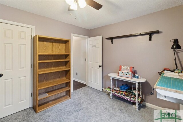 interior space featuring ceiling fan and light carpet