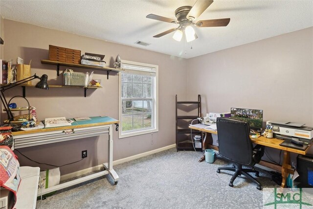 office space featuring ceiling fan, light colored carpet, and a textured ceiling