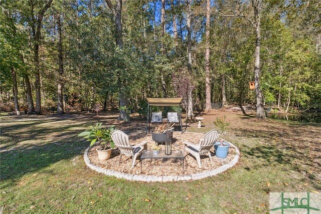 view of yard featuring an outdoor fire pit