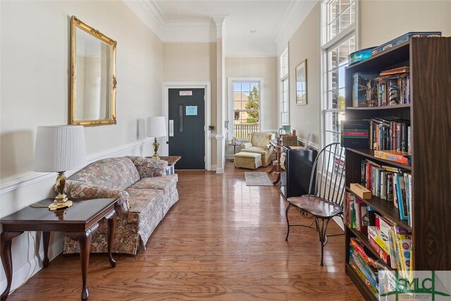 living area featuring ornamental molding and hardwood / wood-style floors