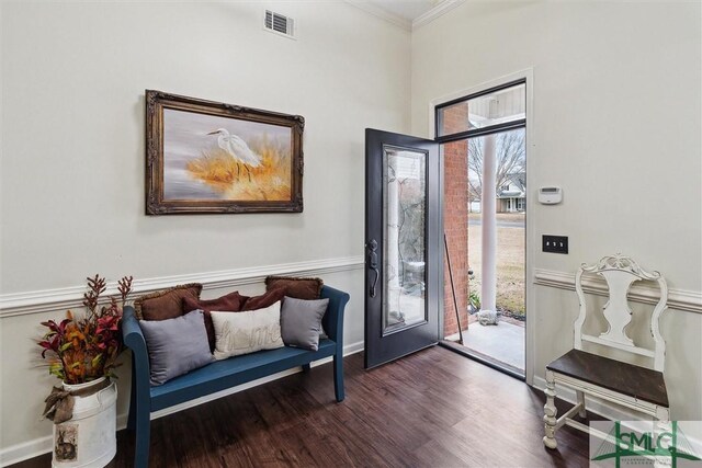 interior space featuring ornamental molding, a healthy amount of sunlight, and dark hardwood / wood-style flooring