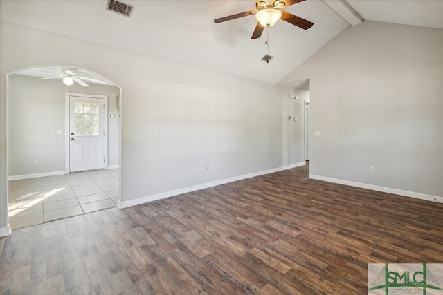 unfurnished room featuring ceiling fan, hardwood / wood-style floors, and vaulted ceiling with beams