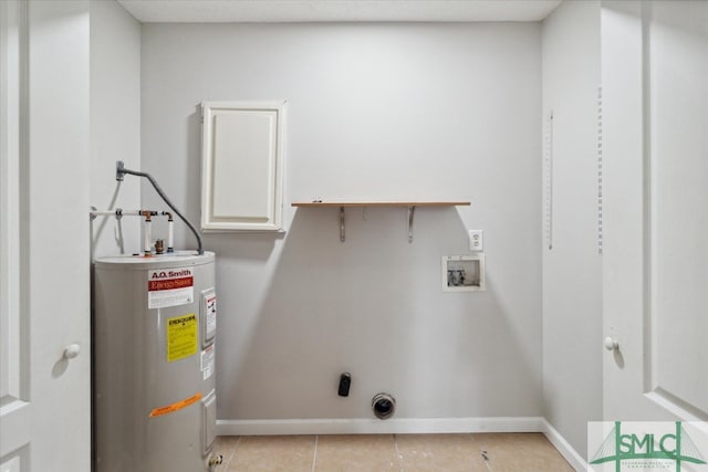 laundry room featuring light tile patterned flooring, cabinets, hookup for a washing machine, and water heater